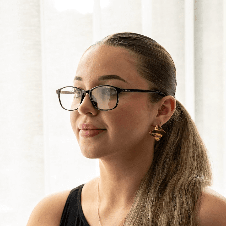 NUYU Afterlight blue light blocking glasses UK worn by woman with ponytail in bright setting