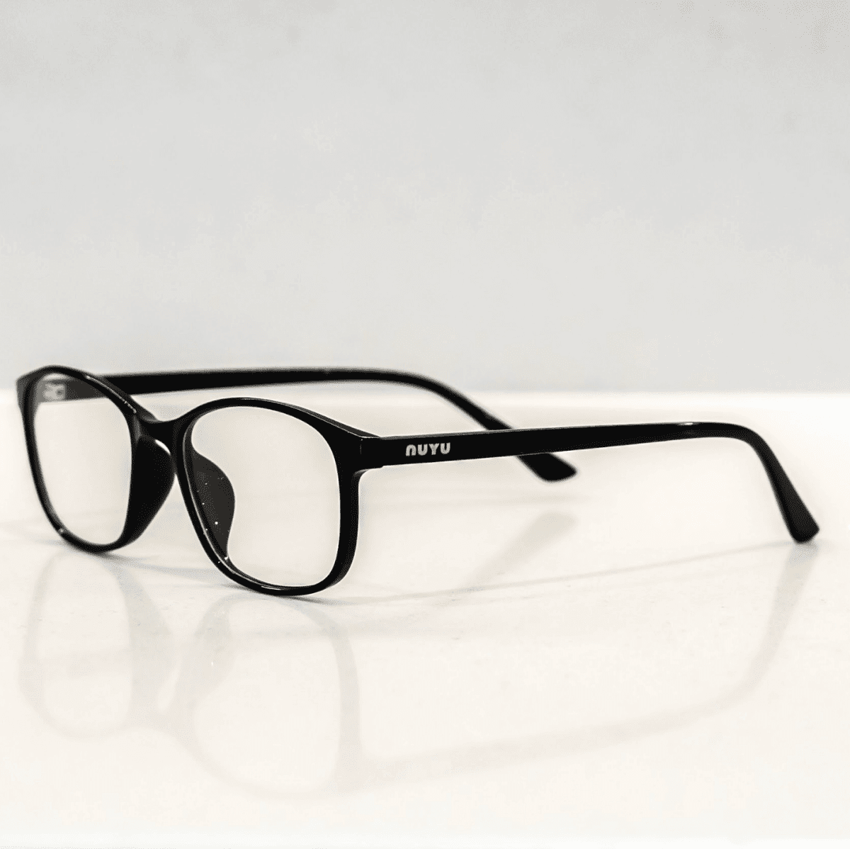 NUYU Afterlight blue light blocking glasses UK with black frames on white surface