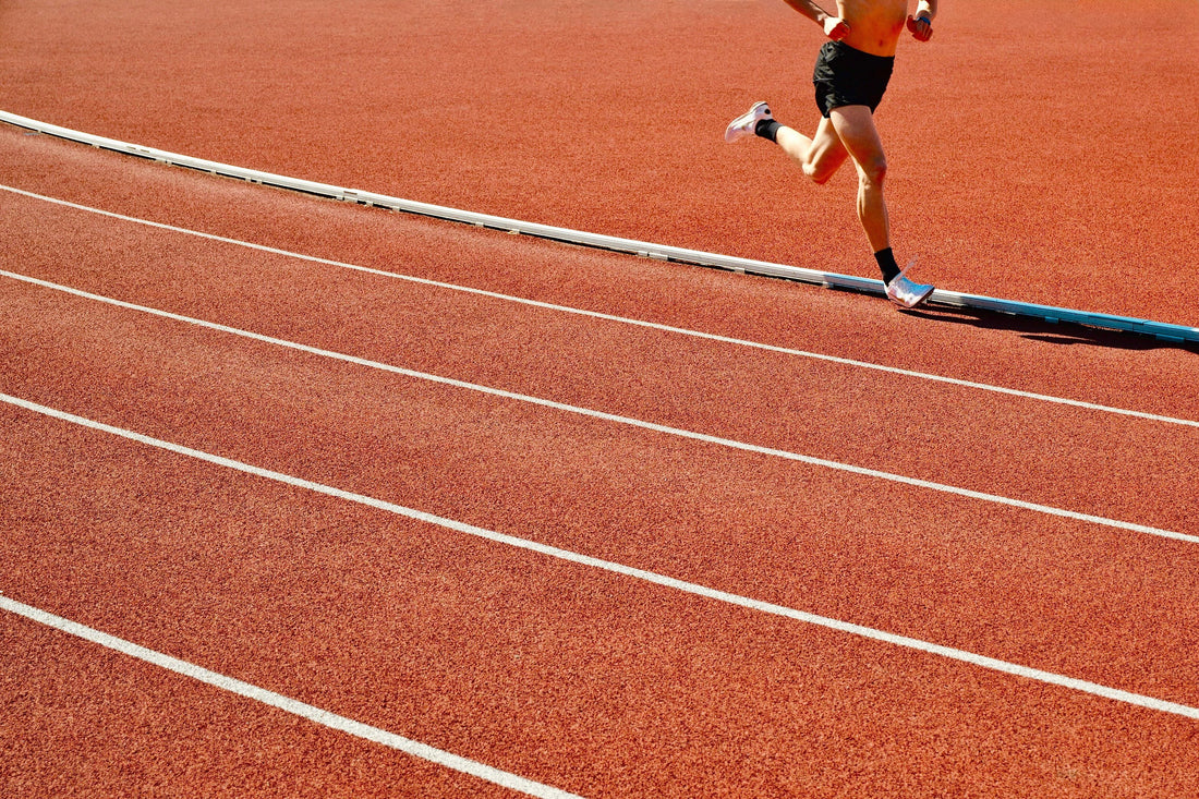 Runner training on an outdoor athletics track