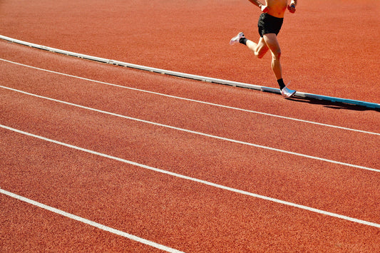 Runner training on an outdoor athletics track