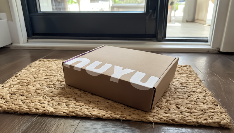 NUYU delivery box on doormat - UK wellness brand magnesium spray supplements