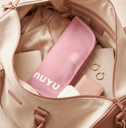 Pink Nuyu travel pouch packed inside beige handbag