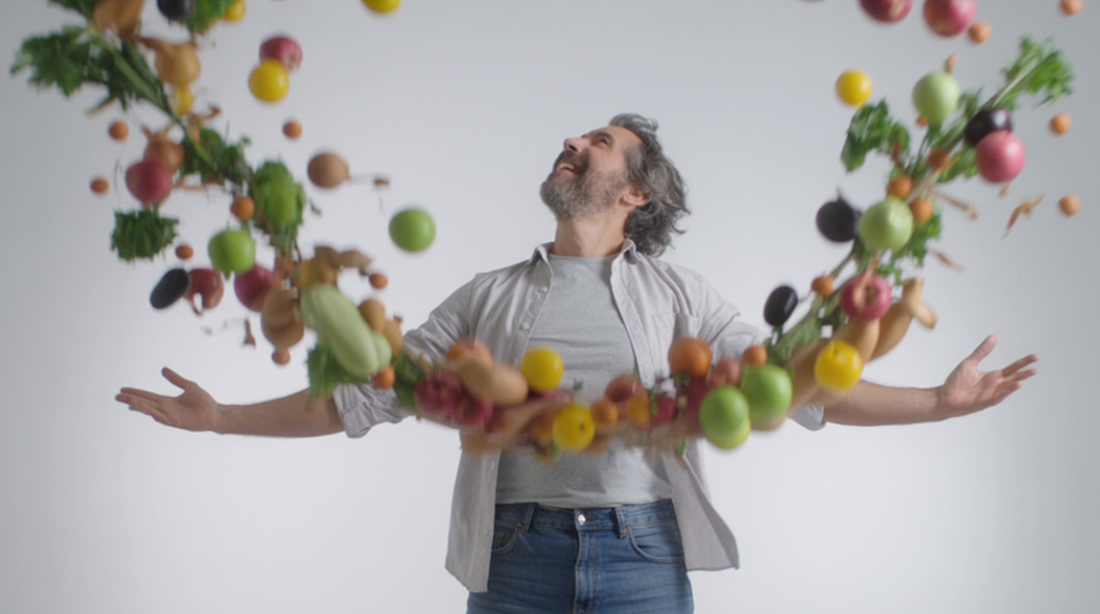 A man surrounded by fruit and vegetables