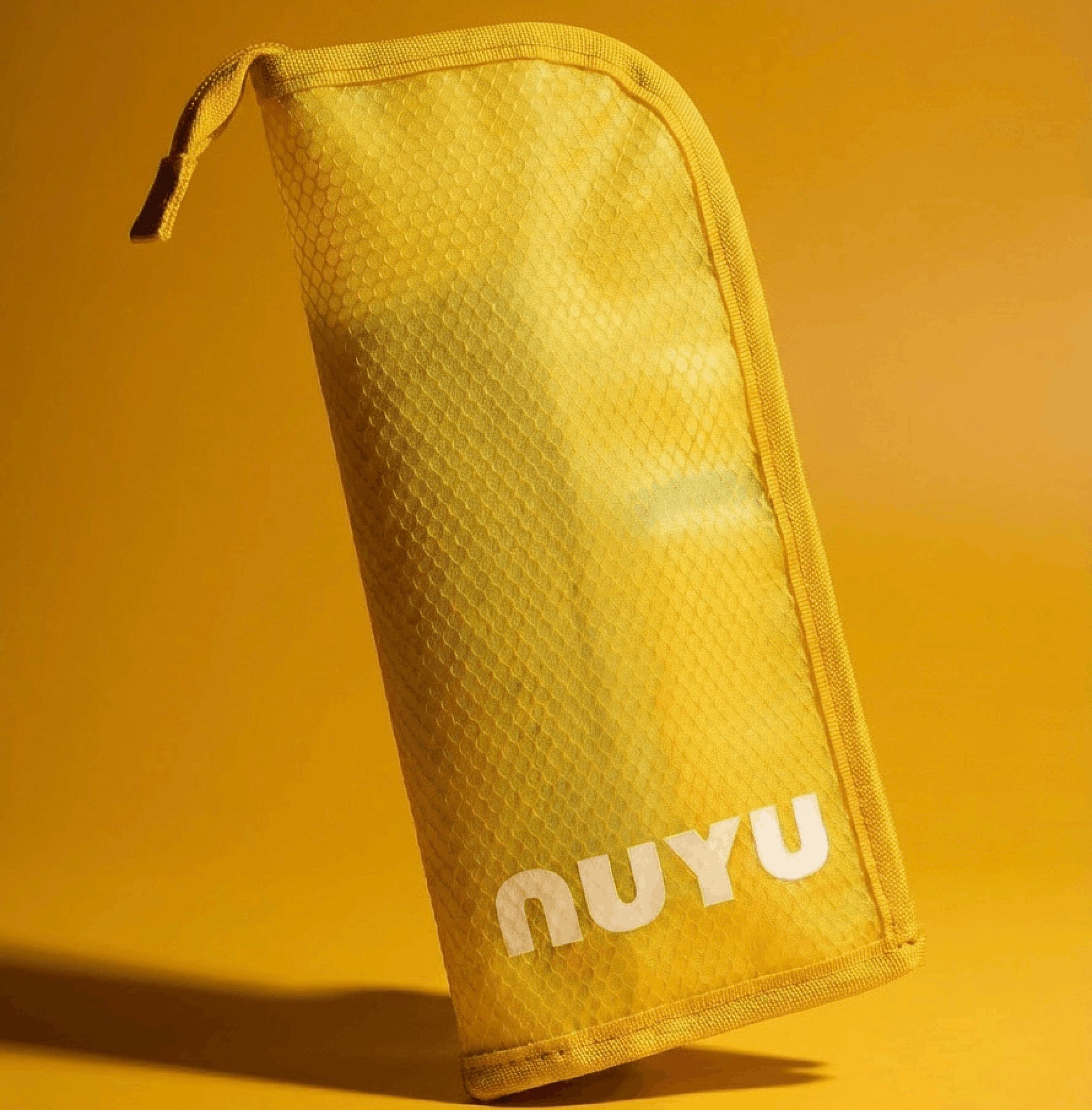 Yellow Nuyu travel pouch on yellow background