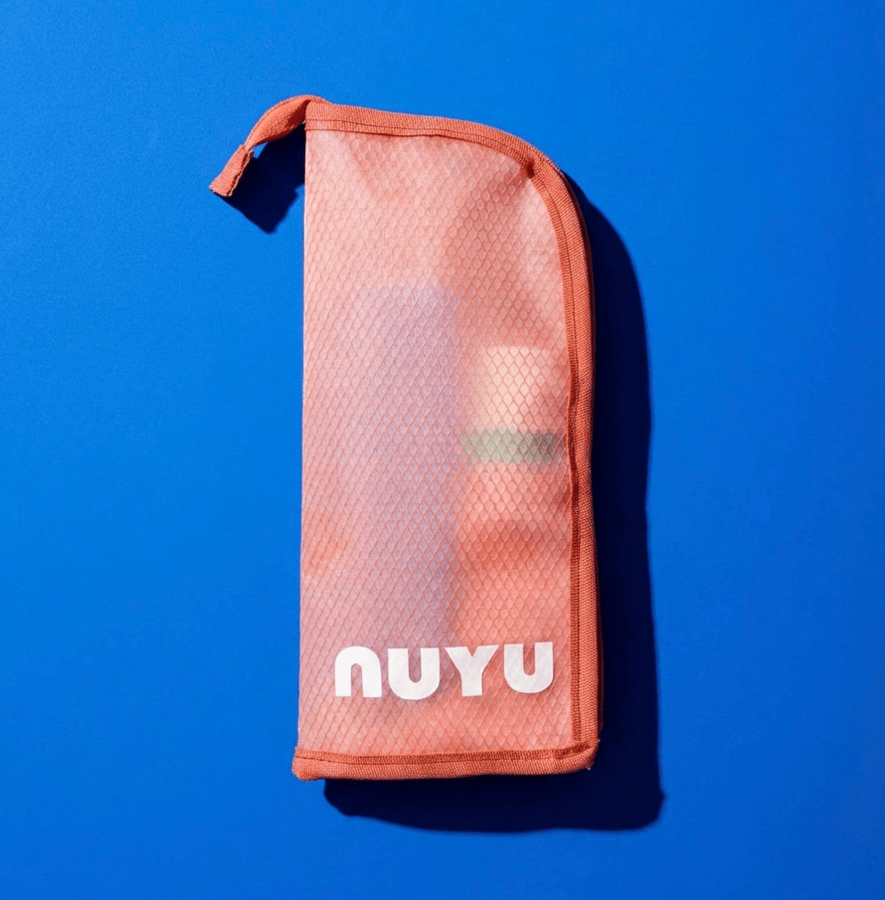 Pink mesh travel pouch with 'NUYU' branding on a blue background