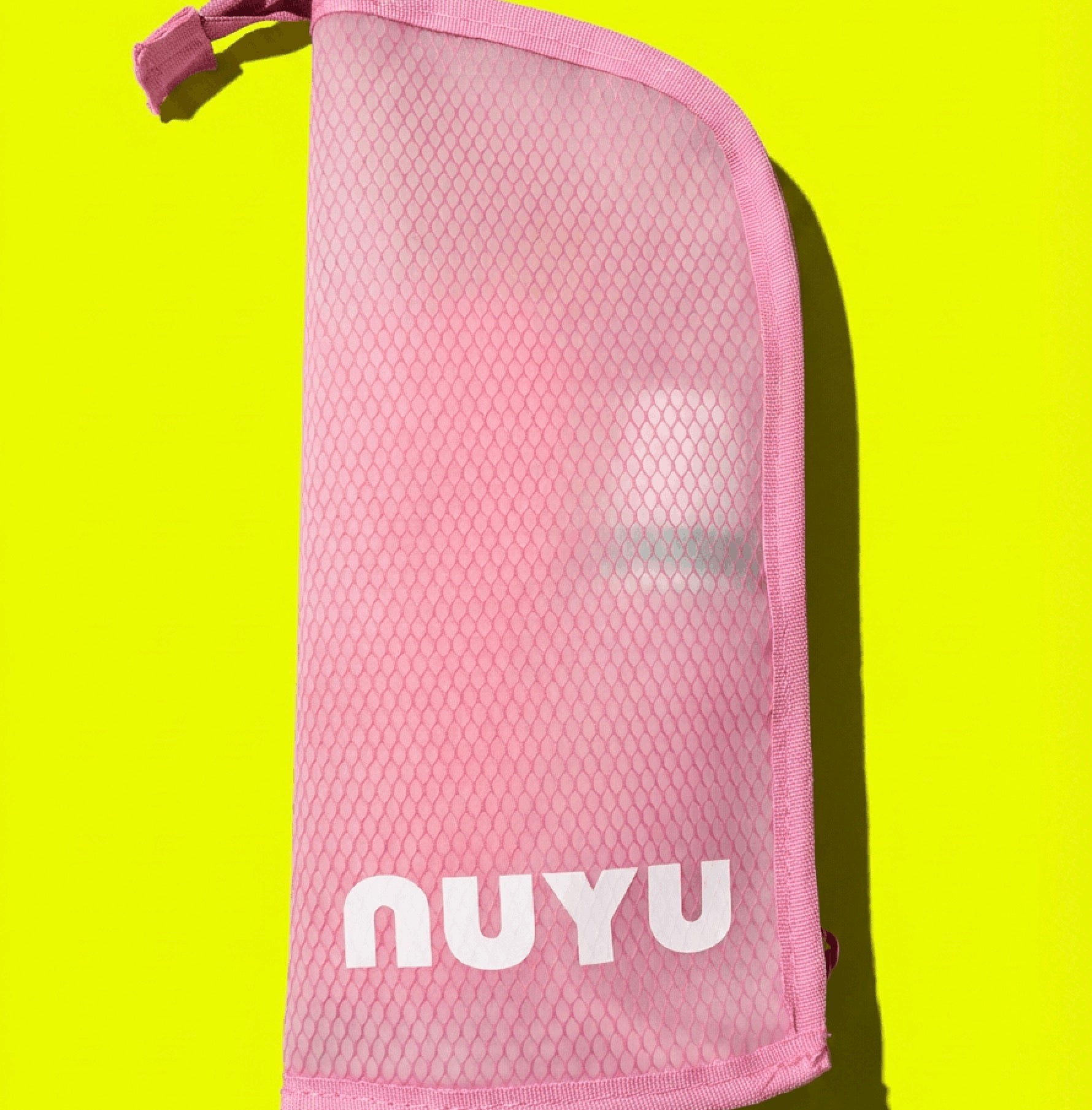 Pink Nuyu travel pouch on bright yellow background
