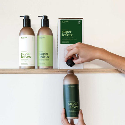 NUYU wellness supplement UK: hands refilling ATTITUDE super leaves shampoo bottles on wooden shelf