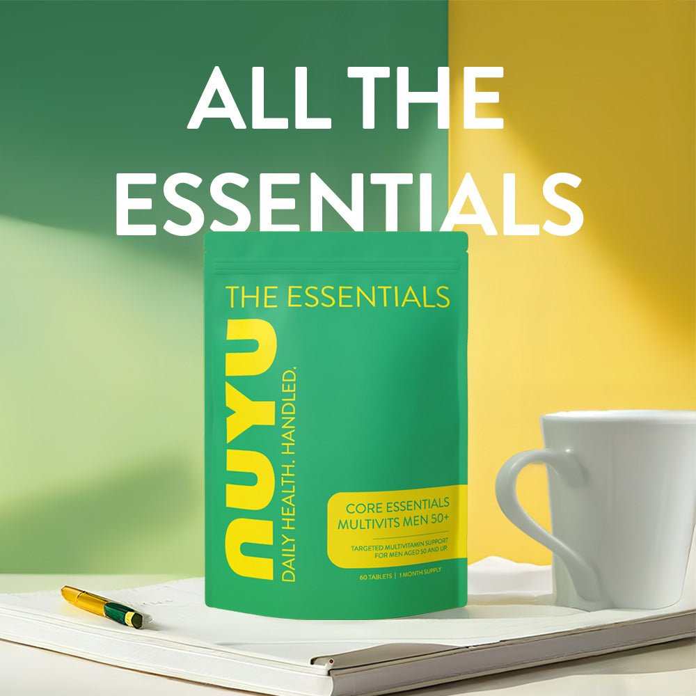 NUYU Core Essentials Men's 50+ multivitamin supplement UK on desk with coffee cup