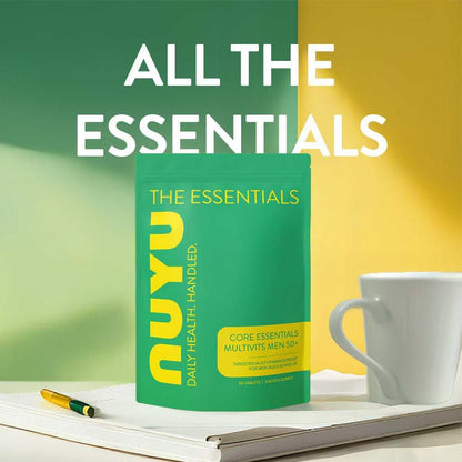 NUYU Core Essentials Men's 50+ multivitamin supplement UK on desk with coffee cup