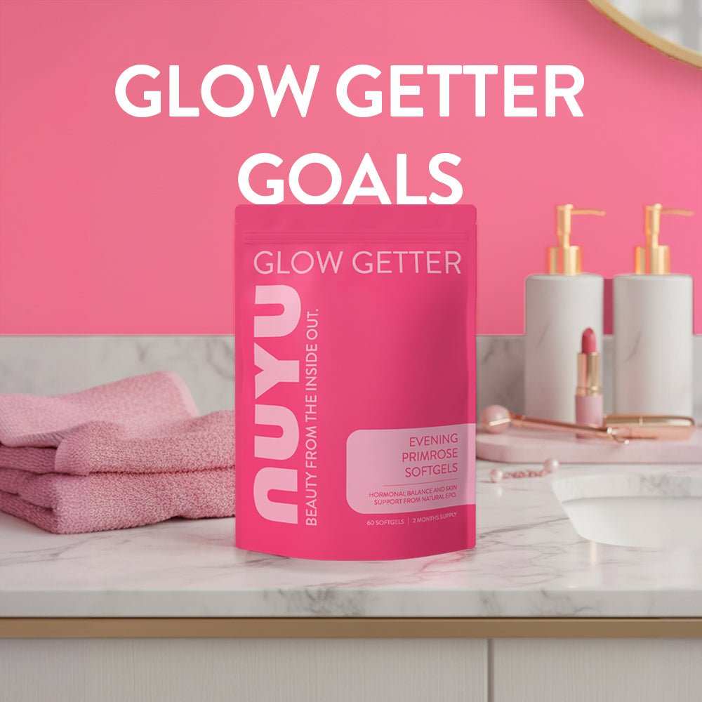 NUYU Evening Primrose Softgels on marble vanity with pink towels, wellness supplement UK