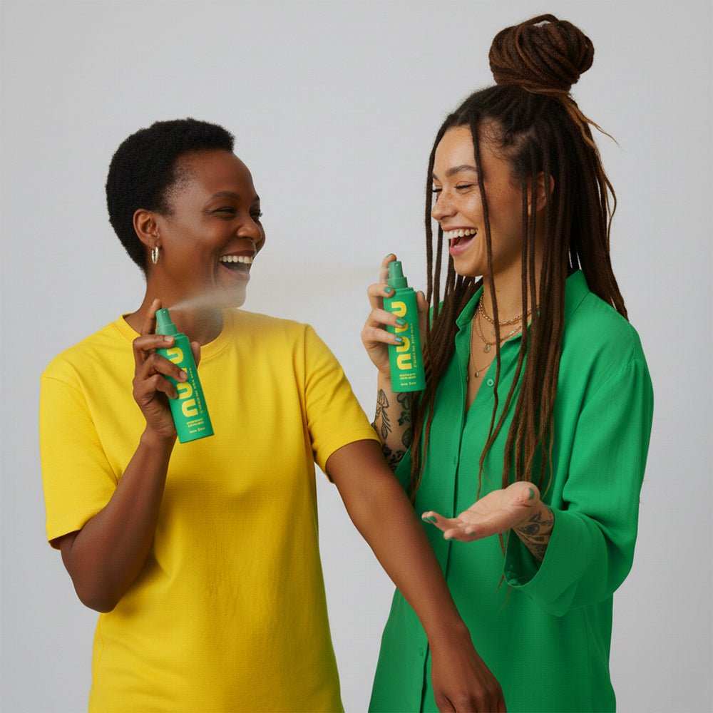 Two smiling women using NUYU Everyday Magnesium Spray for easy magnesium boost