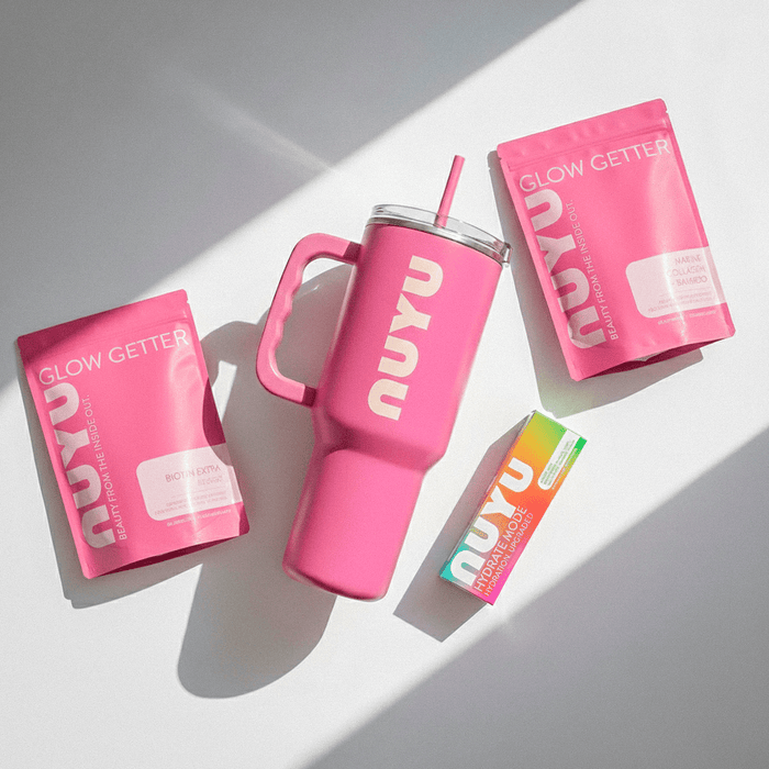 NUYU pink Glow Getter sachets with branded tumbler and straw, daily magnesium spray UK wellness