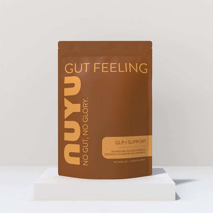 NUYU gut health supplement UK brown pouch packaging on white platform display