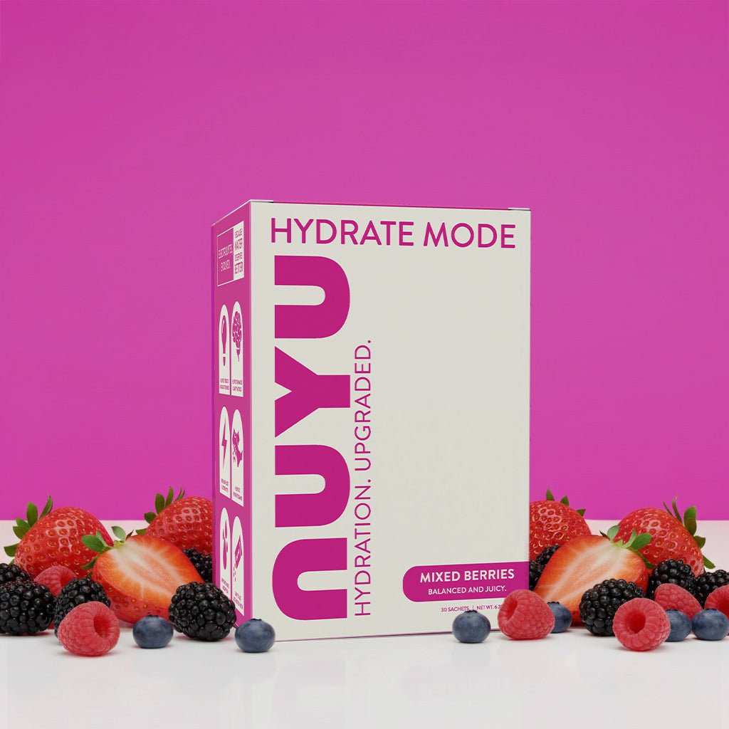 NUYU Hydrate Mode electrolyte sachets UK mixed berry box with fresh berries on pink