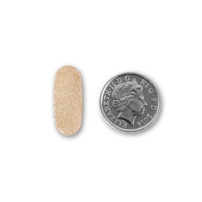 NUYU Maca Root wellness supplement UK capsule size comparison with British coin on white background