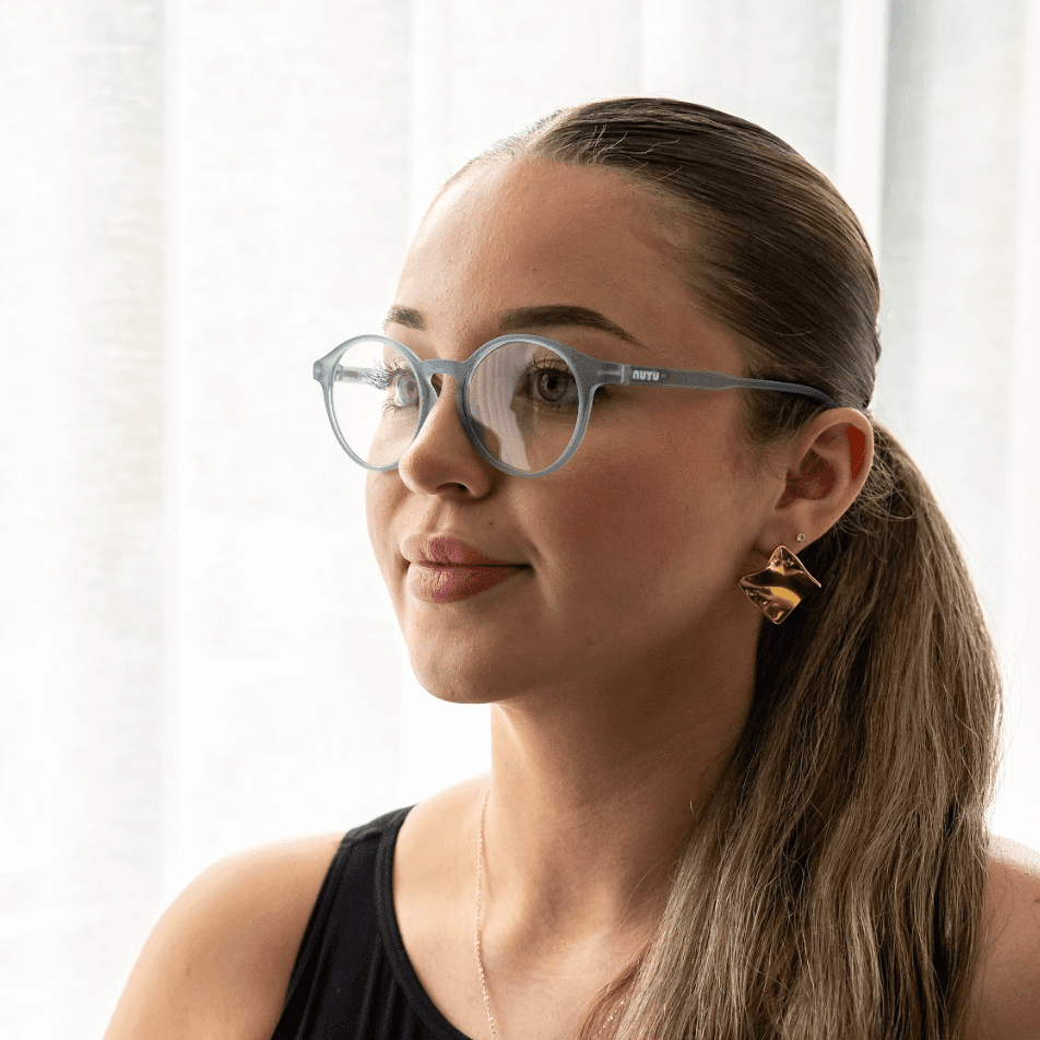 NUYU Afterlight blue light blocking glasses UK worn by woman with sleek ponytail