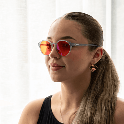NUYU Afterlight blue light blocking glasses UK worn by woman with ponytail and earrings