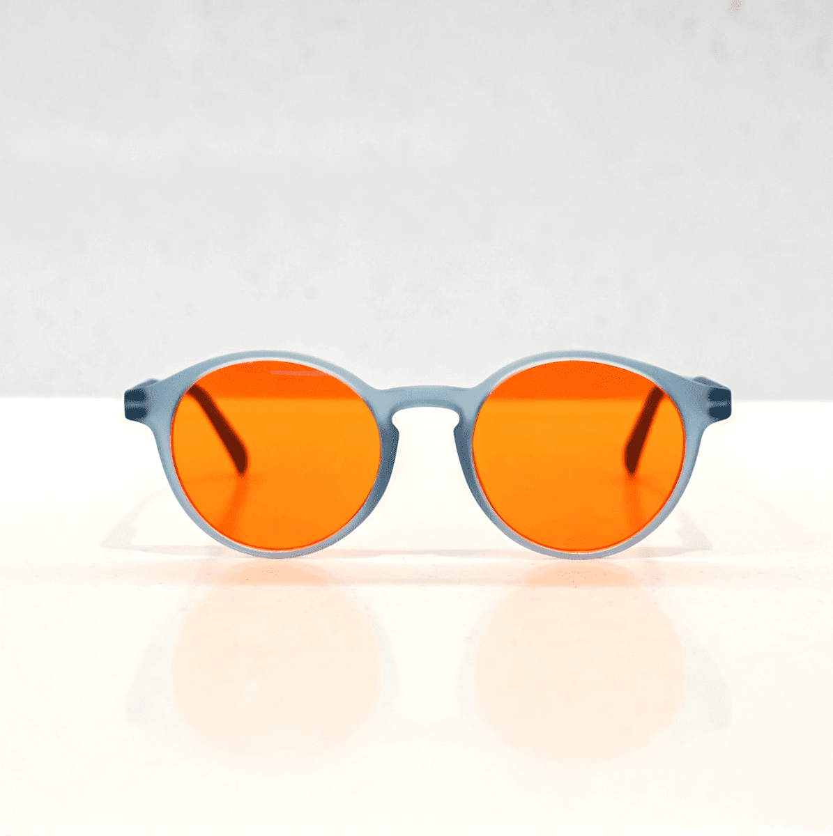 NUYU Afterlight blue light blocking glasses UK with orange lenses and grey frame on white