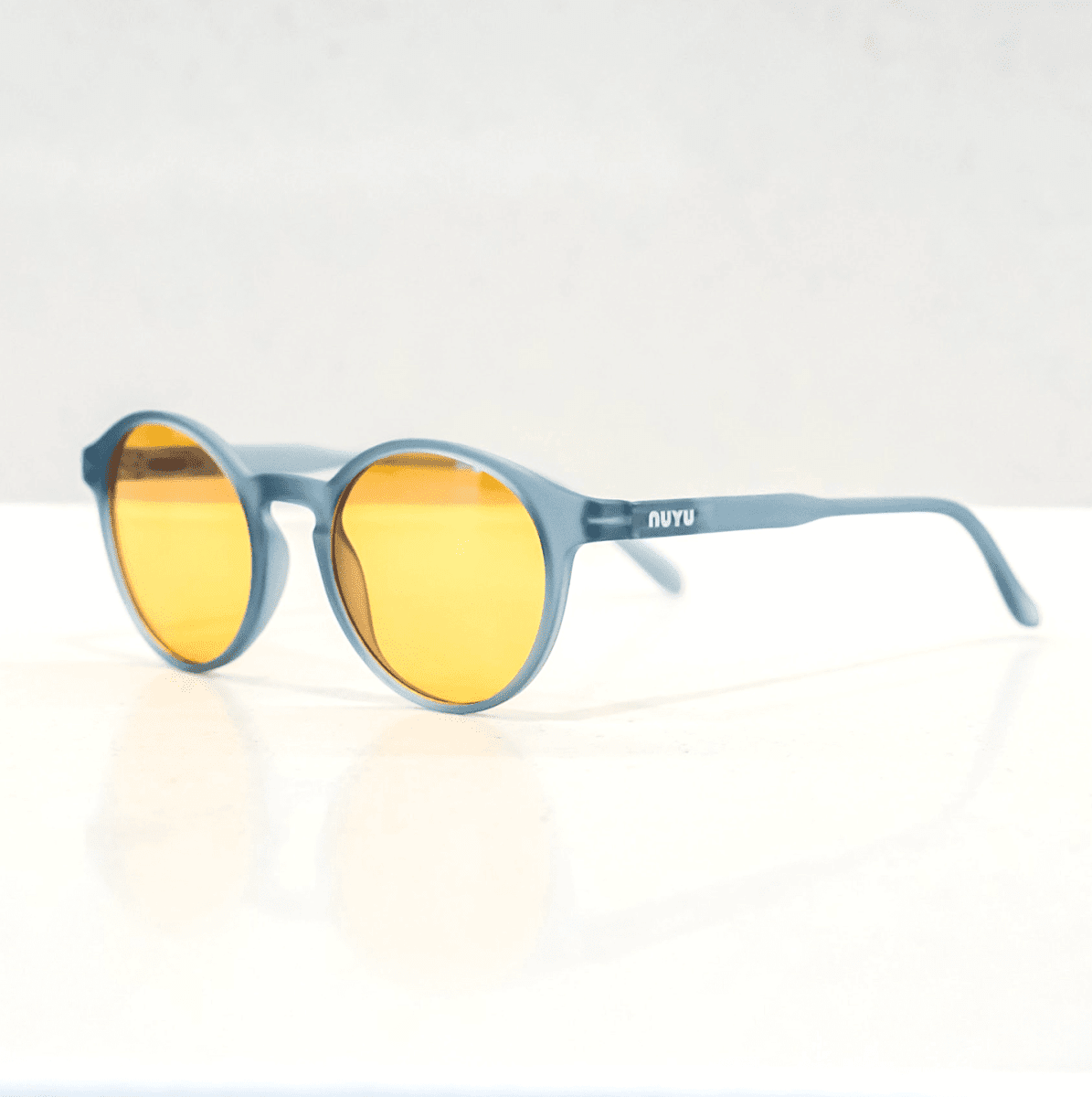 NUYU blue light blocking glasses UK with yellow lenses and grey frames on white background