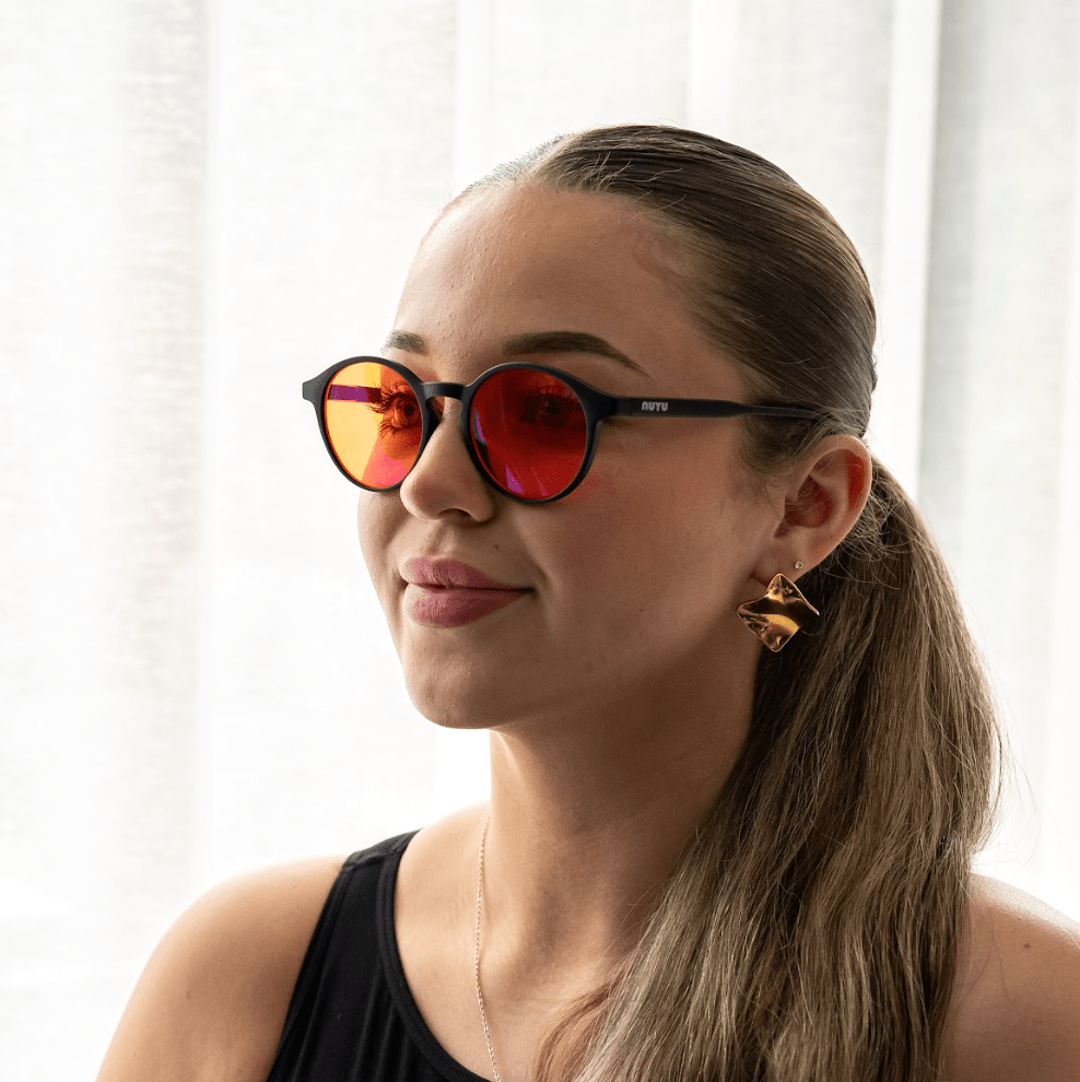 NUYU Afterlight blue light blocking glasses UK worn by woman with gold earrings