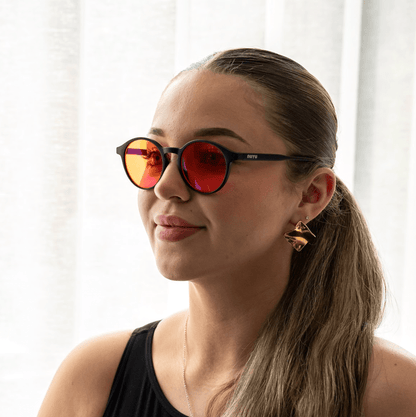 NUYU Afterlight blue light blocking glasses UK worn by woman with gold earrings