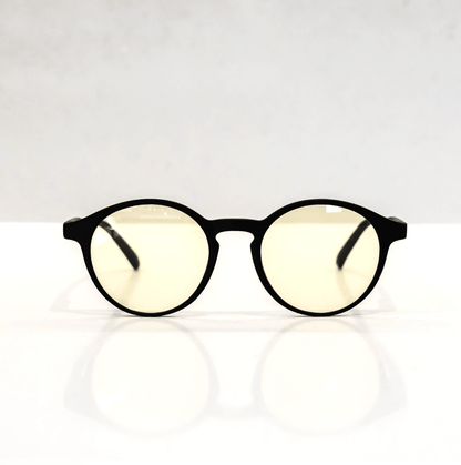 NUYU Afterlight blue light blocking glasses UK with black frames and yellow lenses on white surface