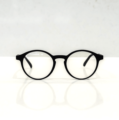 NUYU Afterlight blue light blocking glasses UK - black round frames on white surface
