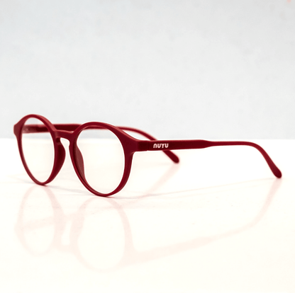 NUYU Afterlight blue light blocking glasses UK in red frame on white reflective surface