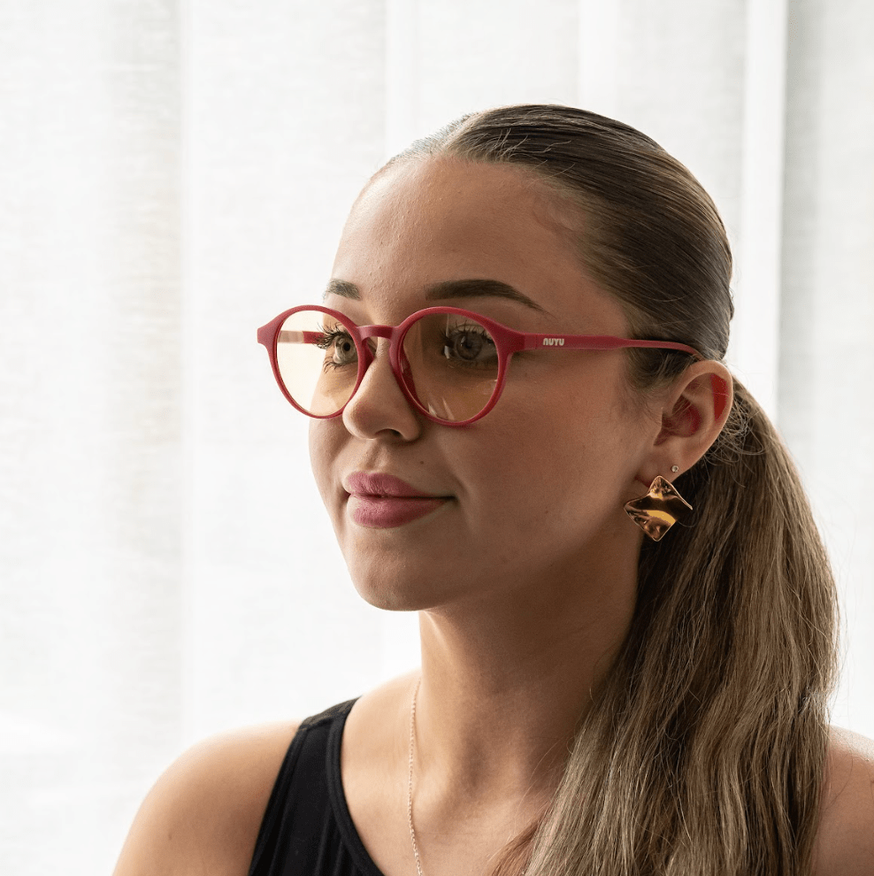 NUYU Afterlight blue light blocking glasses UK worn by woman with gold earrings