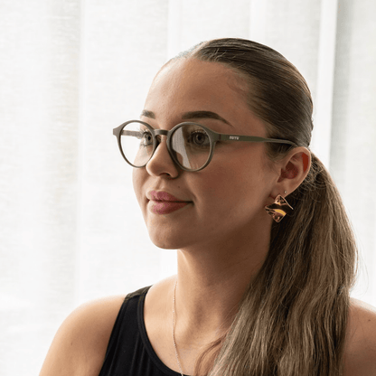 NUYU Afterlight blue light blocking glasses UK styled on woman with gold earrings