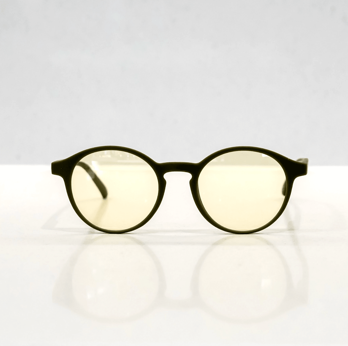 NUYU Afterlight blue light blocking glasses UK with yellow tinted lenses on white surface