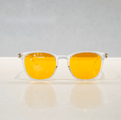 NUYU Afterlight blue light blocking glasses UK with clear frames and amber lenses on white surface