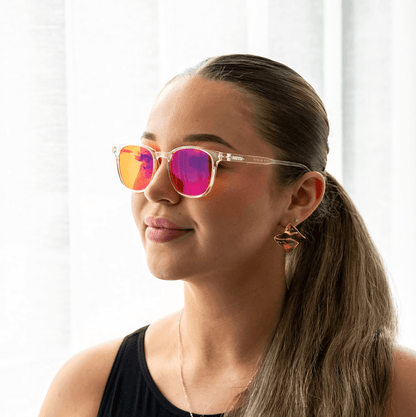 NUYU woman wearing clear frame blue light blocking glasses UK with pink mirrored lenses