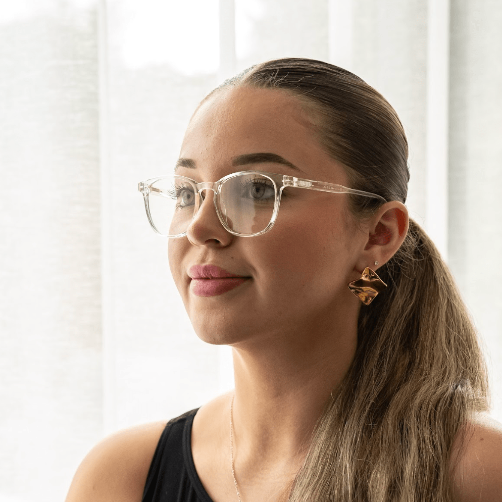 NUYU Afterlight blue light blocking glasses UK worn by woman with ponytail and earrings