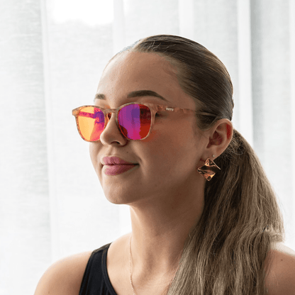 NUYU Afterlight blue light blocking glasses UK worn by woman with gold earrings