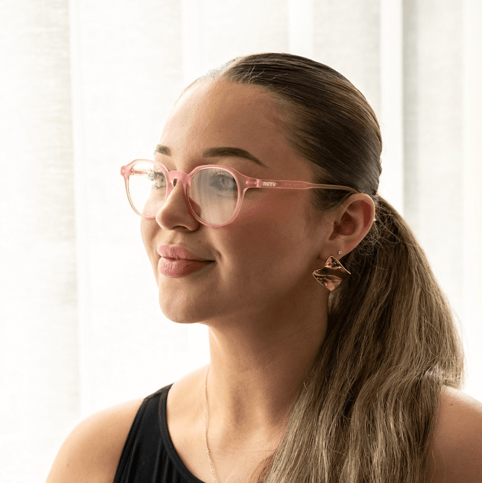 NUYU Afterlight blue light blocking glasses UK worn by woman with pink frames