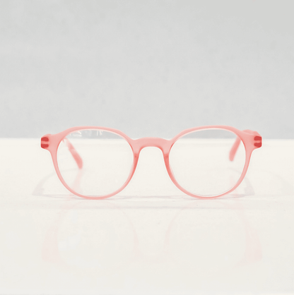 NUYU Afterlight blue light blocking glasses UK in coral pink frames on white surface