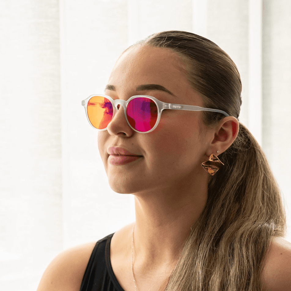 NUYU Afterlight blue light blocking glasses UK worn by woman with ponytail and earrings