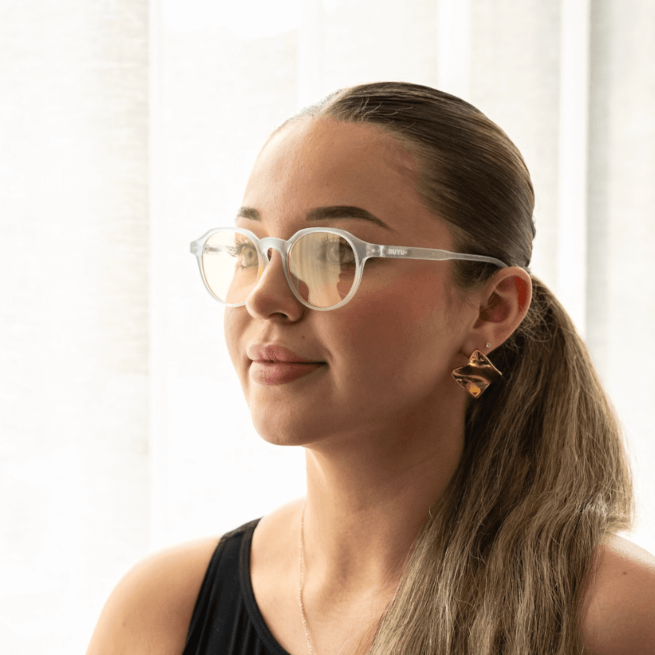NUYU Afterlight blue light blocking glasses UK worn by woman with ponytail in bright setting