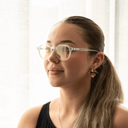 NUYU Afterlight blue light blocking glasses UK worn by woman with ponytail in bright setting