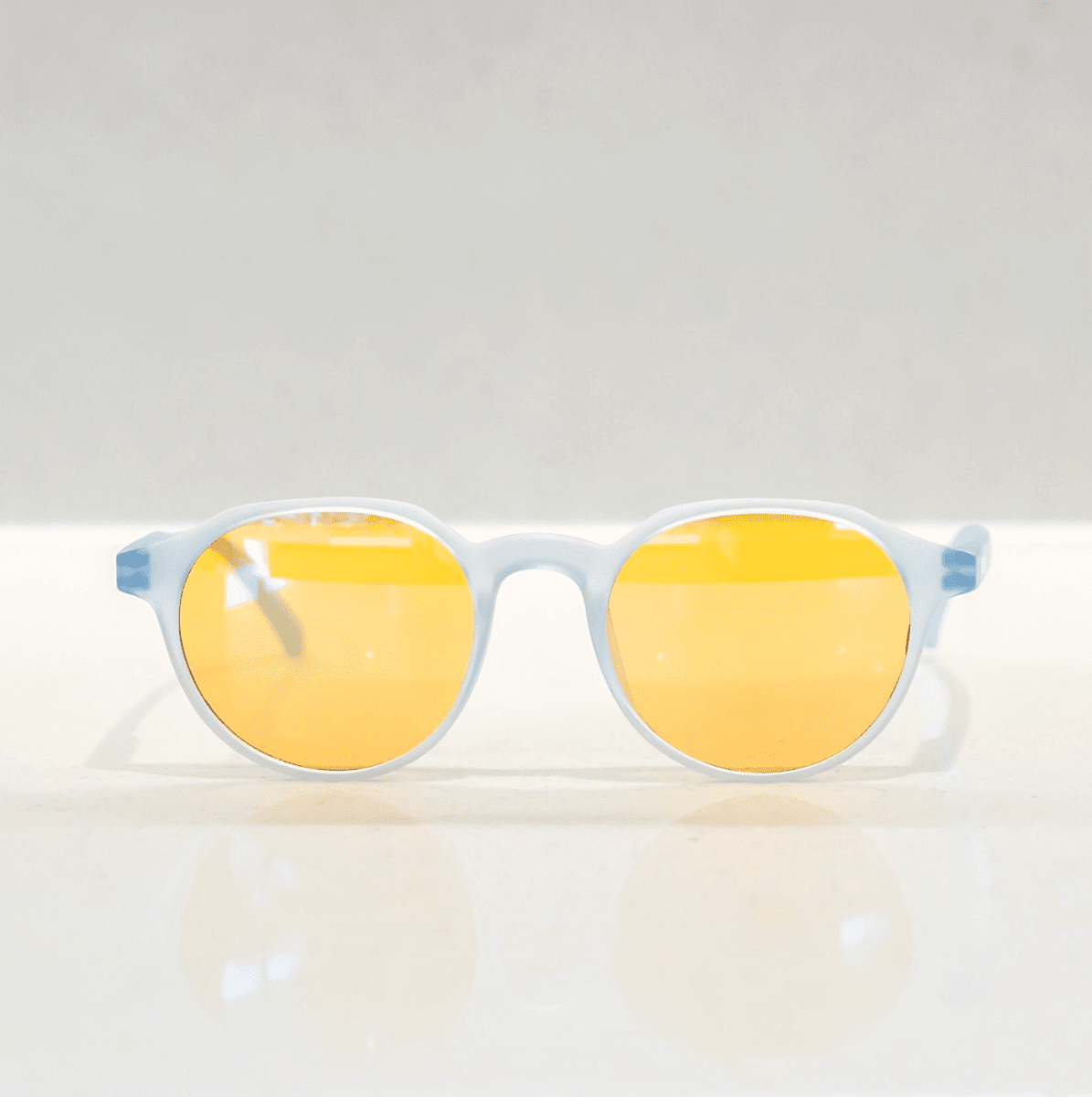 NUYU Afterlight blue light blocking glasses UK with yellow lenses on white surface