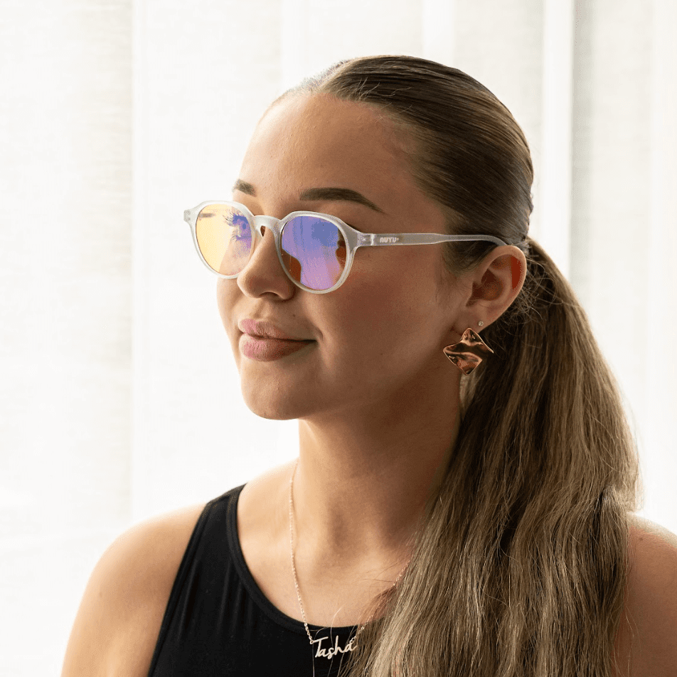 NUYU Afterlight blue light blocking glasses UK worn by woman with gold earrings