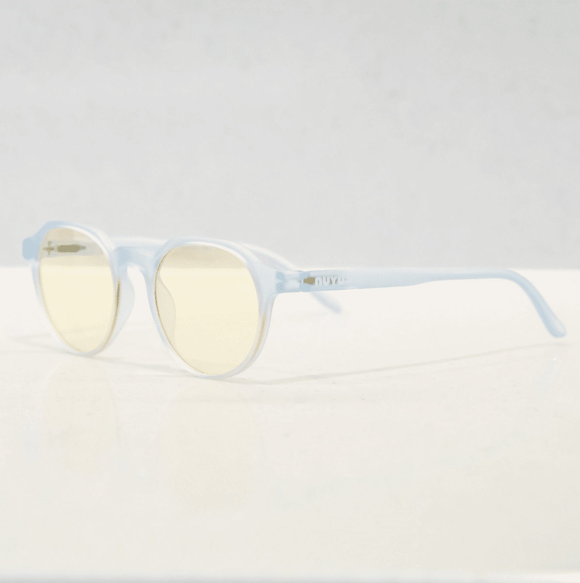 NUYU Afterlight blue light blocking glasses UK in translucent light blue frame with yellow lenses