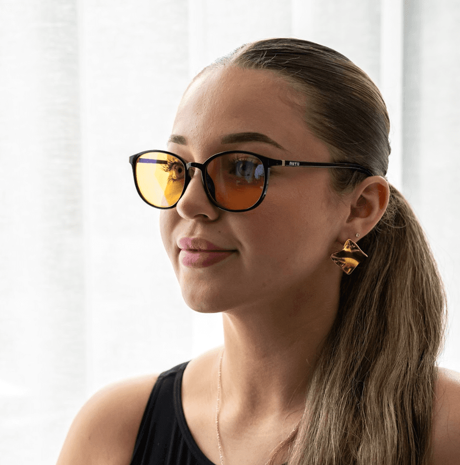 NUYU blue light blocking glasses UK worn by woman with blonde ponytail and gold earrings