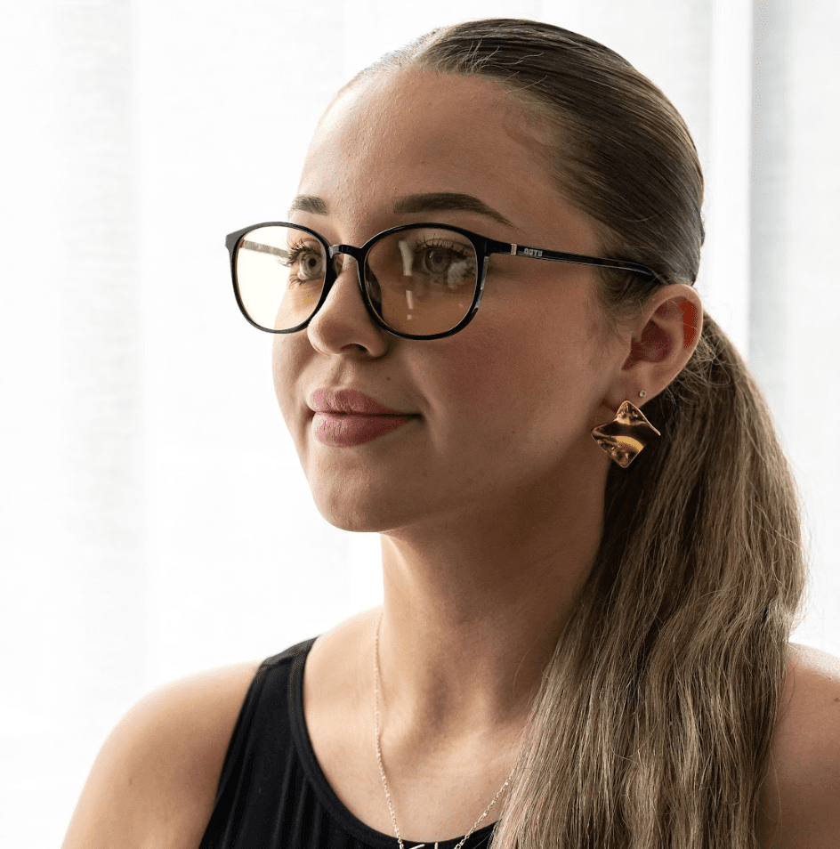 NUYU Afterlight blue light blocking glasses UK worn by woman with gold earrings