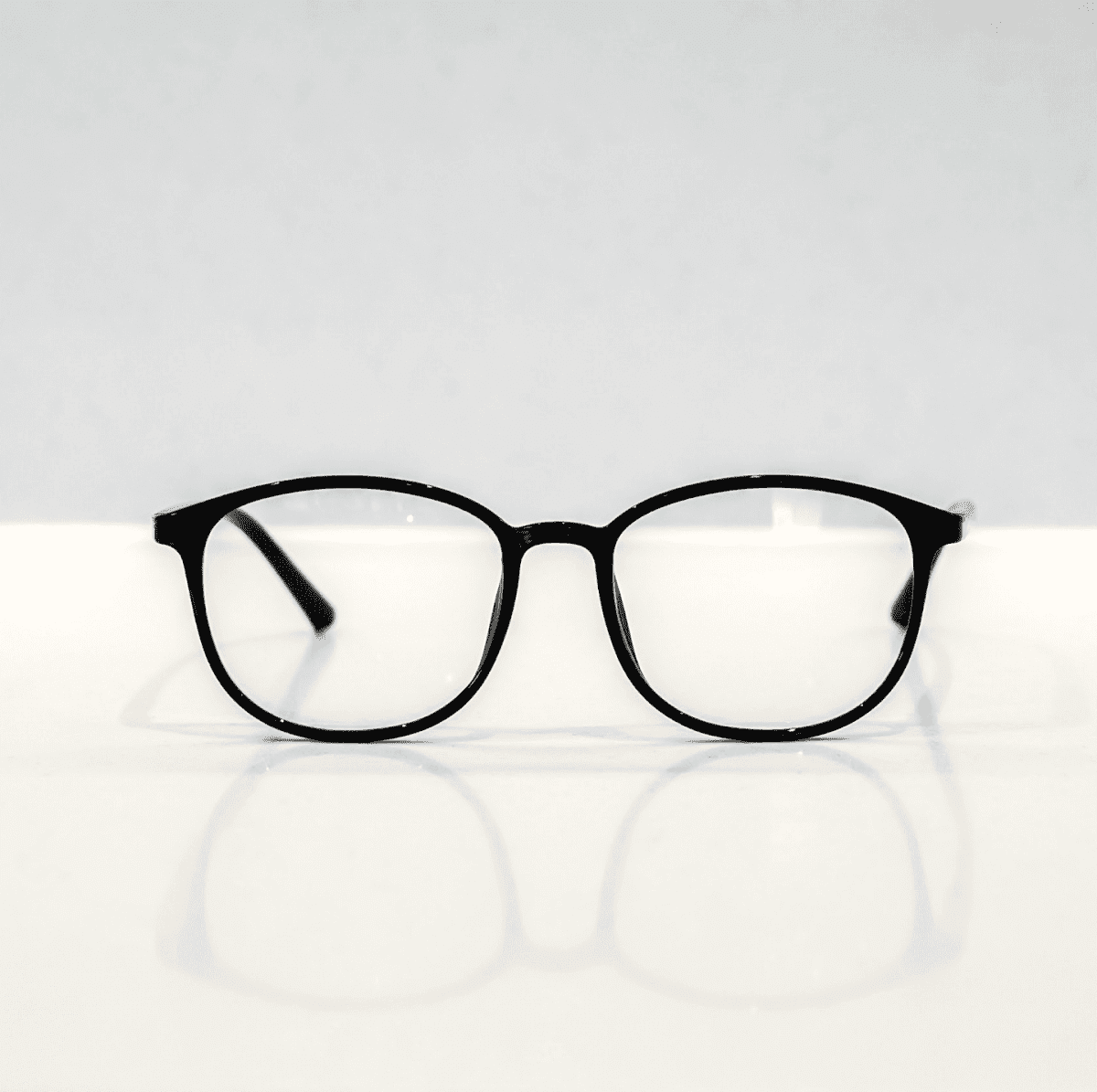 NUYU Afterlight blue light blocking glasses UK with black frames on white surface