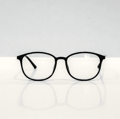 NUYU Afterlight blue light blocking glasses UK with black frames on white surface