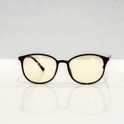 NUYU Afterlight blue light blocking glasses UK with yellow-tinted lenses on white surface