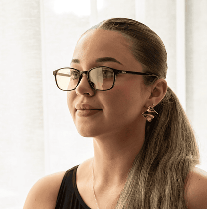 NUYU Afterlight blue light blocking glasses UK worn by woman with sleek ponytail