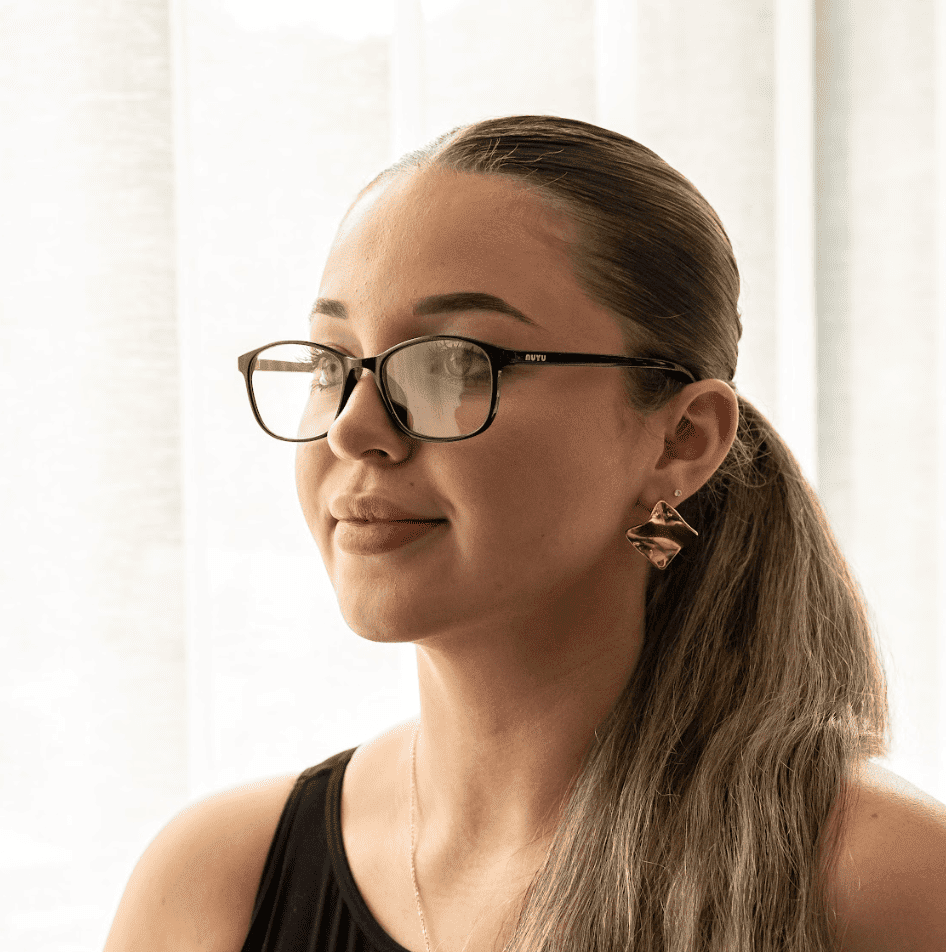 NUYU Afterlight blue light blocking glasses UK worn by woman in bright natural light